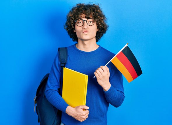 handsome-young-man-exchange-student-holding-germany-flag-looking-camera-blowing-kiss-being-lovely-sexy-love-expression