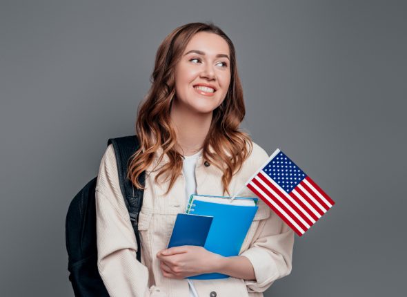 happy-girl-student-holding-backpack-book-notebook-passport-usa-flag-isolated-dark-grey-wall