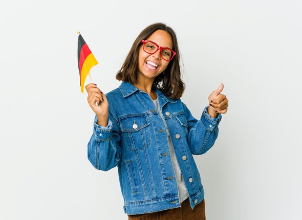 young-woman-holding-german-flag-isolated-white-wall-raising-both-thumbs-up-smiling-confident