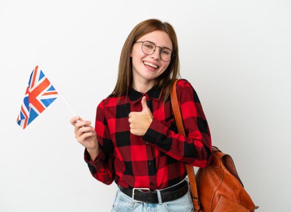 young-woman-holding-united-kingdom-flag-isolated-blue-background-giving-thumbs-up-gesture